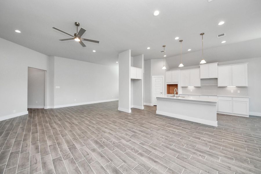 Gather the family and guests together in your lovely living room! Featuring soaring high ceilings, recessed lighting, ceiling fan, custom paint, gorgeous floors, and large windows that provide plenty of natural lighting throughout the day. Gather the family and guests together in your lovely living room! Featuring soaring high ceilings, recessed lighting, ceiling fan, custom paint, gorgeous floors, and large windows that provide plenty of natural lighting throughout the day.