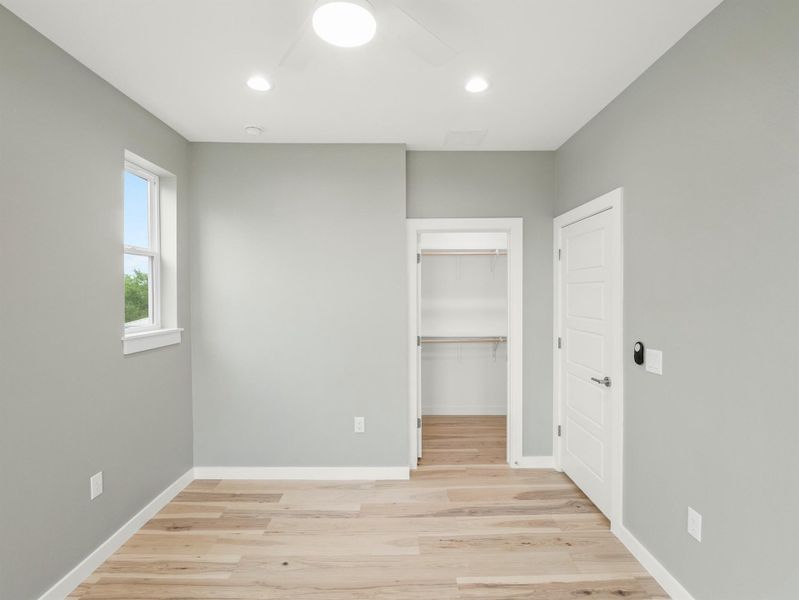Light-toned wood-finish flooring complements soft gray walls