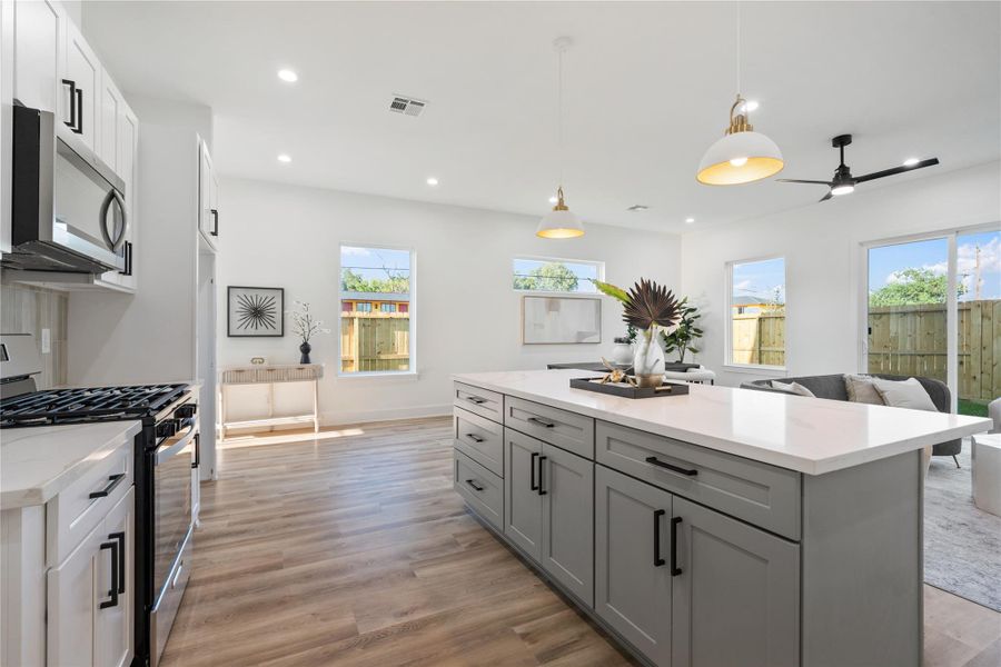 Oversized windows of varying sizes fill the home with natural light and define each space uniquely. They create a bright, airy atmosphere while highlighting the open and functional layout. This thoughtful design enhances both the beauty and livability of every room.