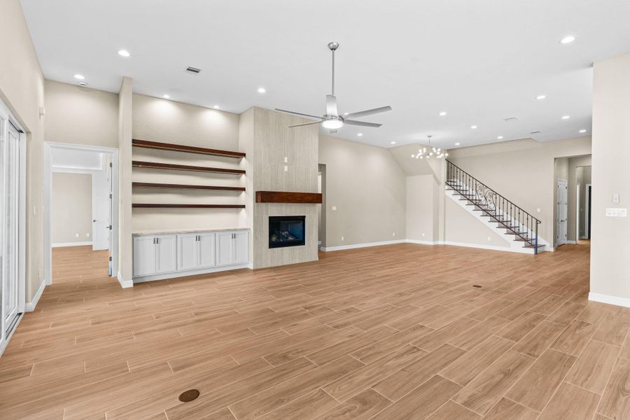 Alternate perspective of the main living area showing the elegant fireplace feature wall and spacious design.