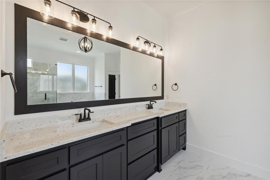 Bathroom featuring vanity and a shower with shower door