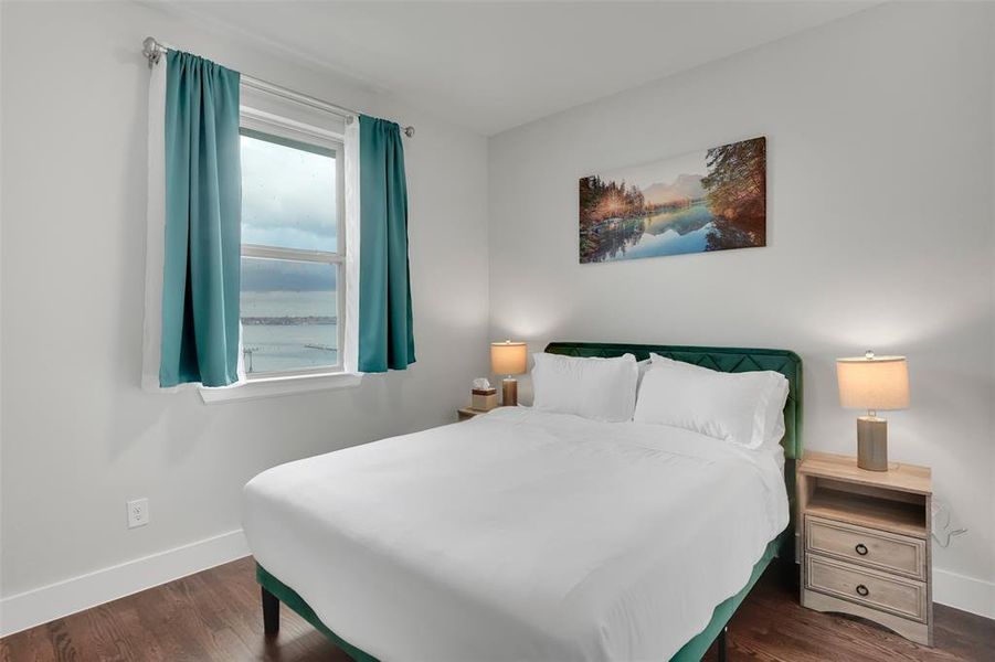 Bedroom featuring baseboards and dark wood-style floors