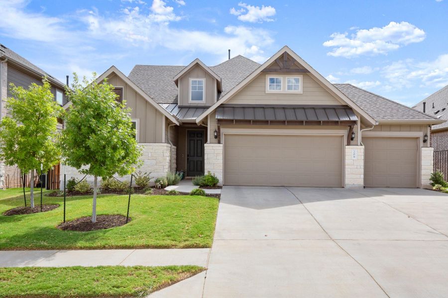 Craftsman house with roof with shingles, a standing seam roof, board and batten siding, stone siding, and driveway Craftsman house with roof with shingles, a standing seam roof, board and batten siding, stone siding, and driveway