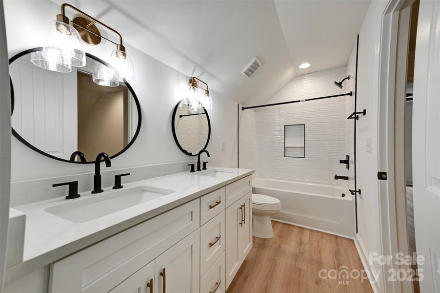 Upstairs bath with dual sinks. Door to hallway and to bedroom Upstairs bath with dual sinks. Door to hallway and to bedroom