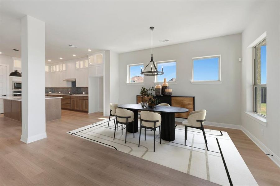 Dining space featuring light wood finished floors and recessed lighting