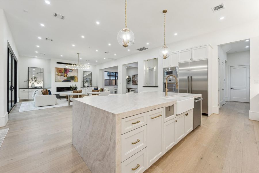 The kitchen seamlessly connects to the living, dining and breakfast areas, featuring a spacious walk-in pantry, custom cabinetry, and a functional prep kitchen, ideal for both everyday use and entertaining.
