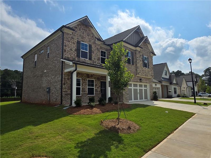 Front exterior of a new home in Pinecrest Ridge, Dacula, GA, highlighting curb appeal (Image 16).