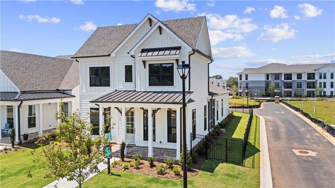 Front exterior of a new home in Promenade at Sawnee Village, Cumming, GA, highlighting curb appeal (Image 21). Front exterior of a new home in Promenade at Sawnee Village, Cumming, GA, highlighting curb appeal (Image 21).