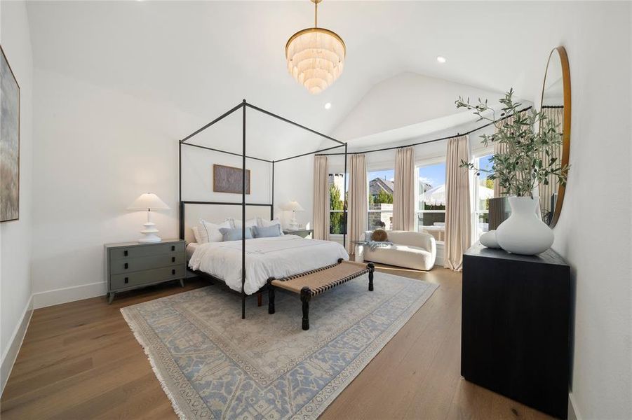 Bedroom with hardwood / wood-style flooring and lofted ceiling