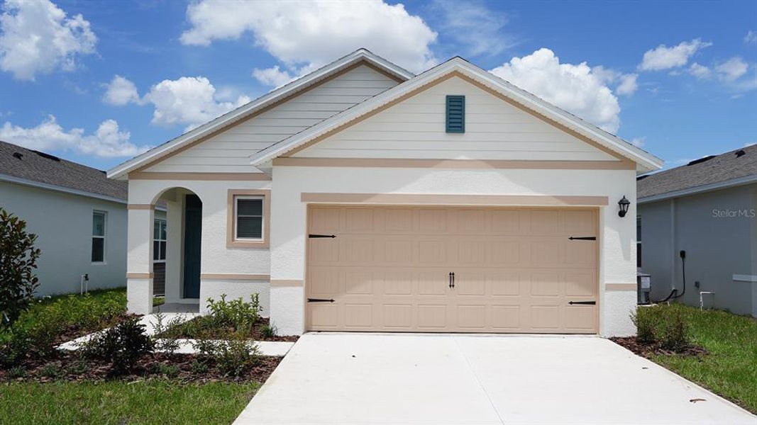 Front exterior of a new home in Villamar, Winter Haven, FL, highlighting curb appeal (Image 1). Front exterior of a new home in Villamar, Winter Haven, FL, highlighting curb appeal (Image 1).