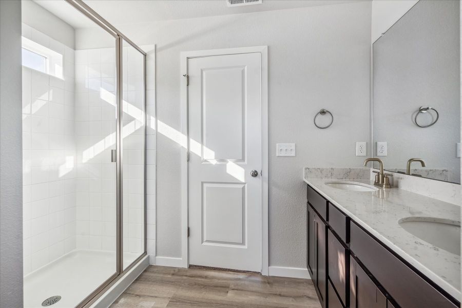A bathroom with a glass shower. A bathroom with a glass shower.