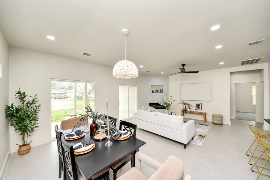 Open concept living area connects to a private patio, offering easy outdoor access. The design creates a bright and airy atmosphere, maximizing natural light. Enjoy abundant sunlight and stylish patio doors.