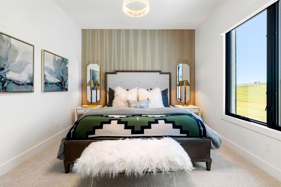 Bedroom with an accent wall, carpet floors, and wallpapered walls Bedroom with an accent wall, carpet floors, and wallpapered walls