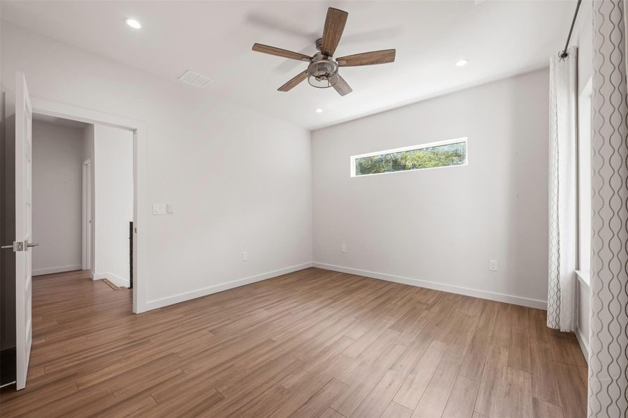 Unfurnished bedroom featuring a ceiling fan, light wood finished floors, and recessed lighting