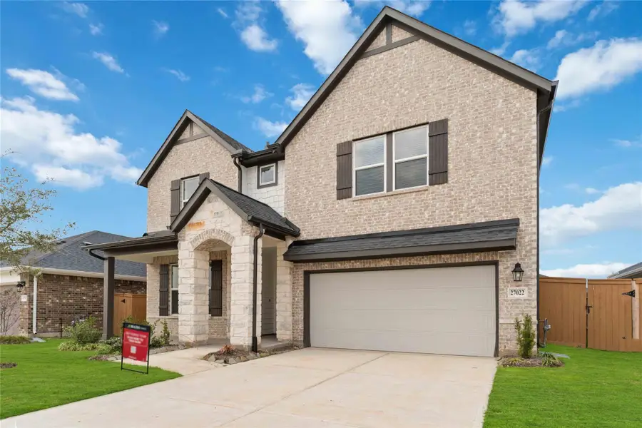 Front exterior of a new home in Sunterra, Katy, TX, highlighting curb appeal (Image 1). Front exterior of a new home in Sunterra, Katy, TX, highlighting curb appeal (Image 1).