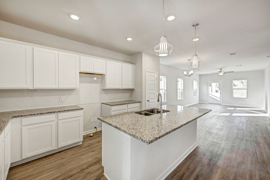 Kitchen into Family Room. Sample image for illustration; upgrades, options, and colors may vary. Kitchen into Family Room. Sample image for illustration; upgrades, options, and colors may vary.