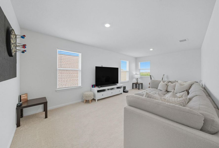 Living area with light colored carpet and recessed lighting Living area with light colored carpet and recessed lighting