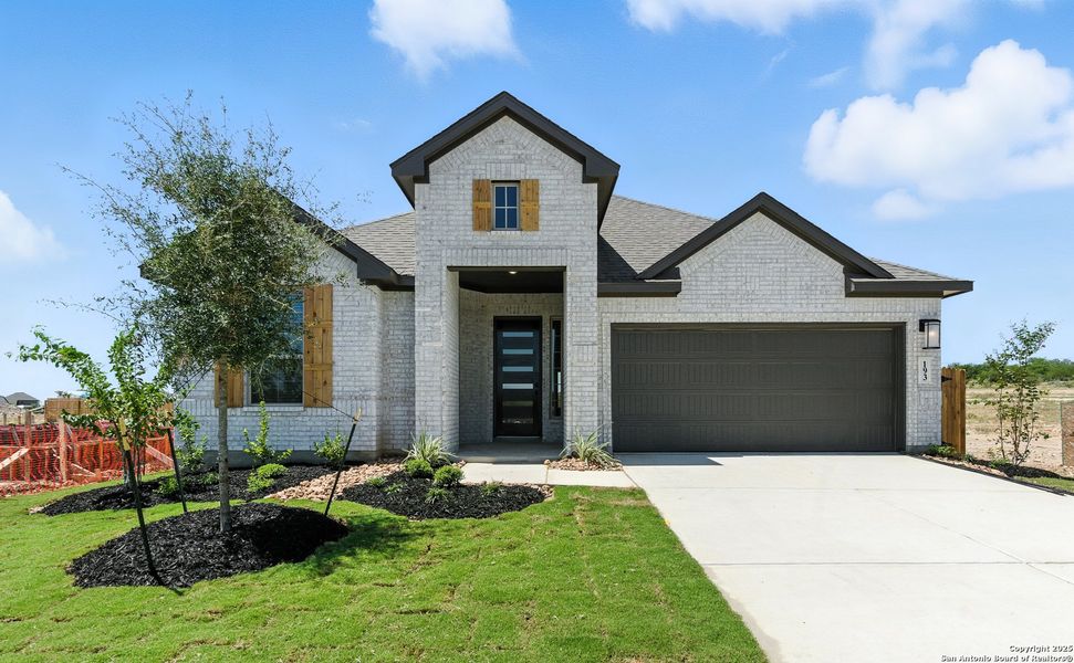 Front exterior of a new home in Alsatian Oaks, Castroville, TX, highlighting curb appeal (Image 1).