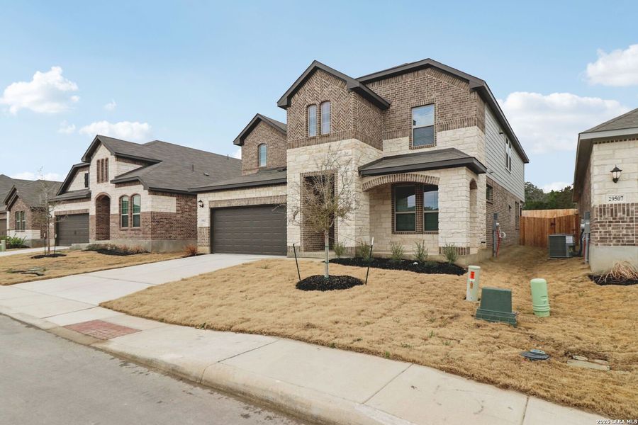 Front exterior of a new home in Fox Falls, Boerne, TX, highlighting curb appeal (Image 26). Front exterior of a new home in Fox Falls, Boerne, TX, highlighting curb appeal (Image 26).