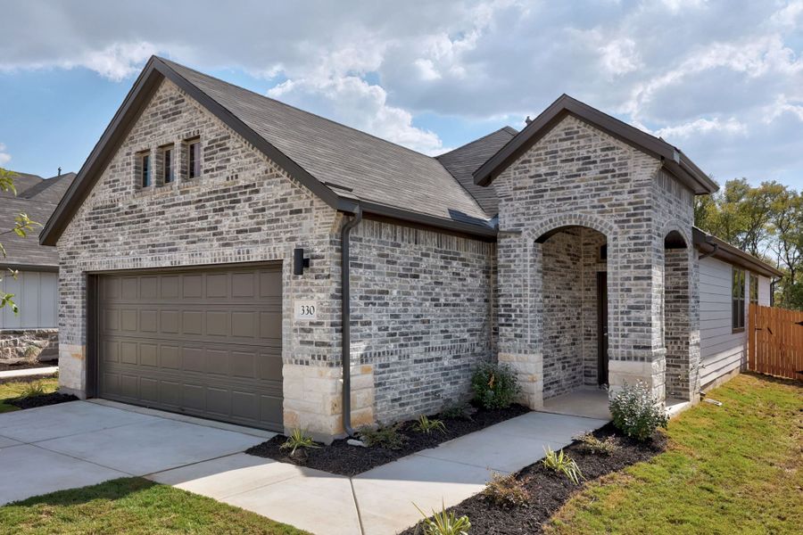 Front exterior of a new home in Trinity Ranch, Elgin, TX, highlighting curb appeal (Image 18).