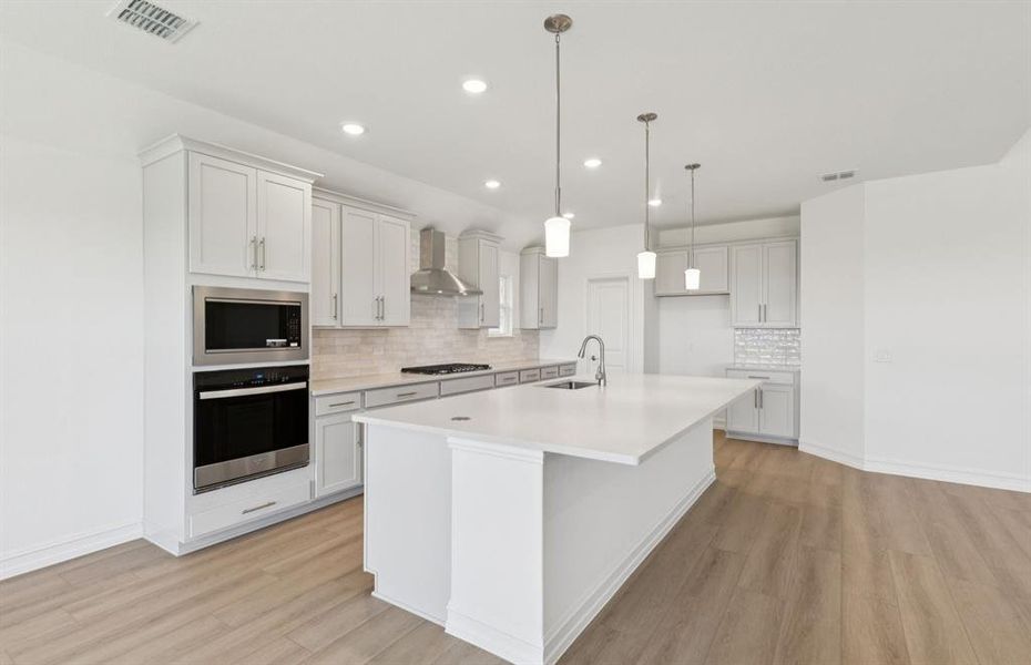 Large island overlooking gathering room and dining areas Large island overlooking gathering room and dining areas