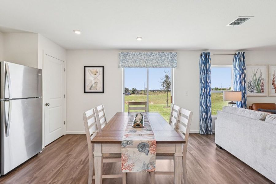 A dining room with a table and chairs.