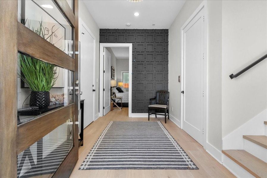 Step inside to a grand entryway that immediately sets the tone, offering access to the first bedroom, garage, and an elevator that carries you to every level, all the way to the rooftop. Step inside to a grand entryway that immediately sets the tone, offering access to the first bedroom, garage, and an elevator that carries you to every level, all the way to the rooftop.