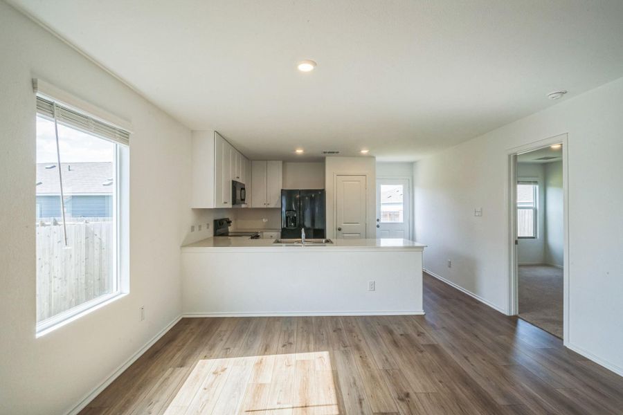An open floorplan seamlessly connects the kitchen and living areas, offering a fluid and inviting atmosphere. An open floorplan seamlessly connects the kitchen and living areas, offering a fluid and inviting atmosphere.
