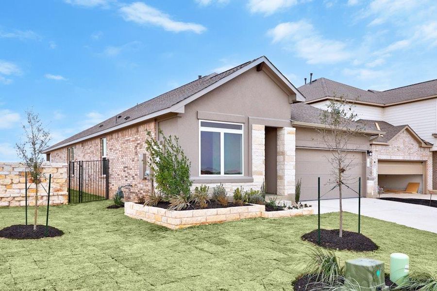 Front exterior of a new home in Santa Rita Ranch, Liberty Hill, TX, highlighting curb appeal (Image 2). Front exterior of a new home in Santa Rita Ranch, Liberty Hill, TX, highlighting curb appeal (Image 2).