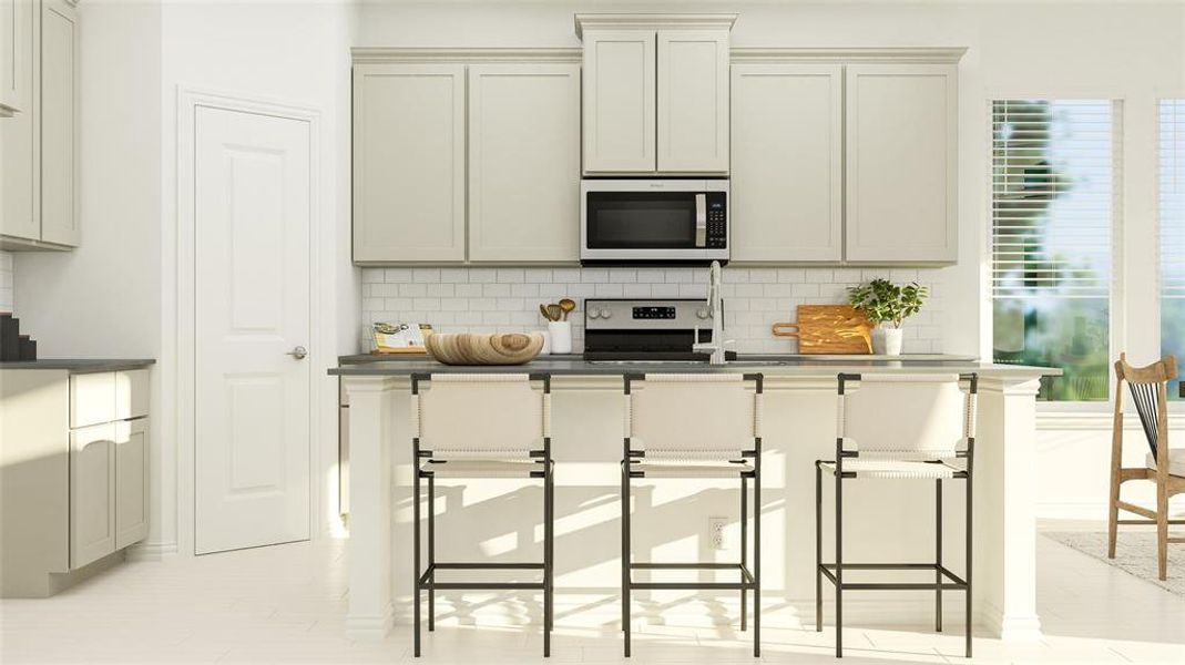 Kitchen with tasteful backsplash, stainless steel appliances, a kitchen breakfast bar, and dark countertops Kitchen with tasteful backsplash, stainless steel appliances, a kitchen breakfast bar, and dark countertops