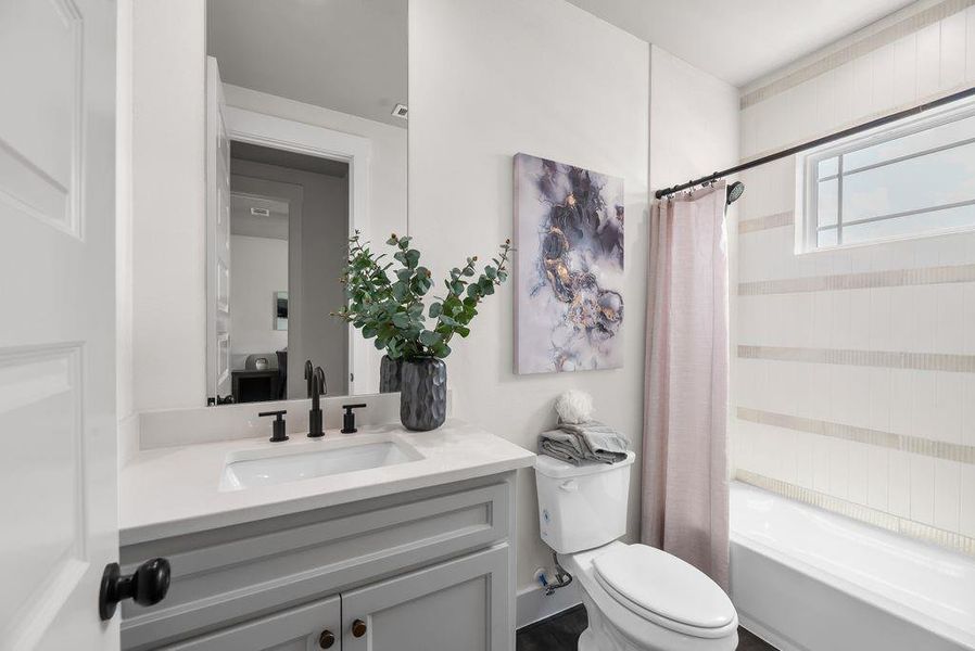 Bathroom featuring shower / tub combo and vanity Bathroom featuring shower / tub combo and vanity