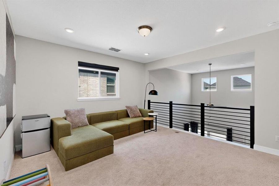 Carpeted living area with recessed lighting and baseboards Carpeted living area with recessed lighting and baseboards