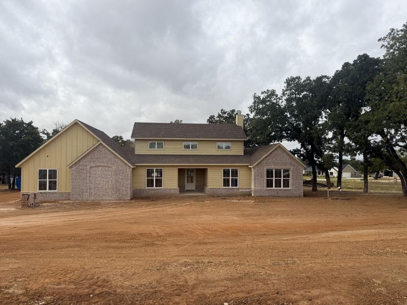 Front exterior of a new home in Monarch Manor, Poolville, TX, highlighting curb appeal (Image 5).