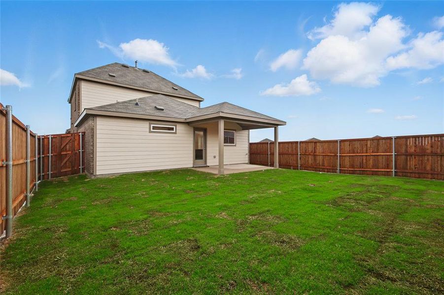 Rear view of property with a patio and a fenced backyard