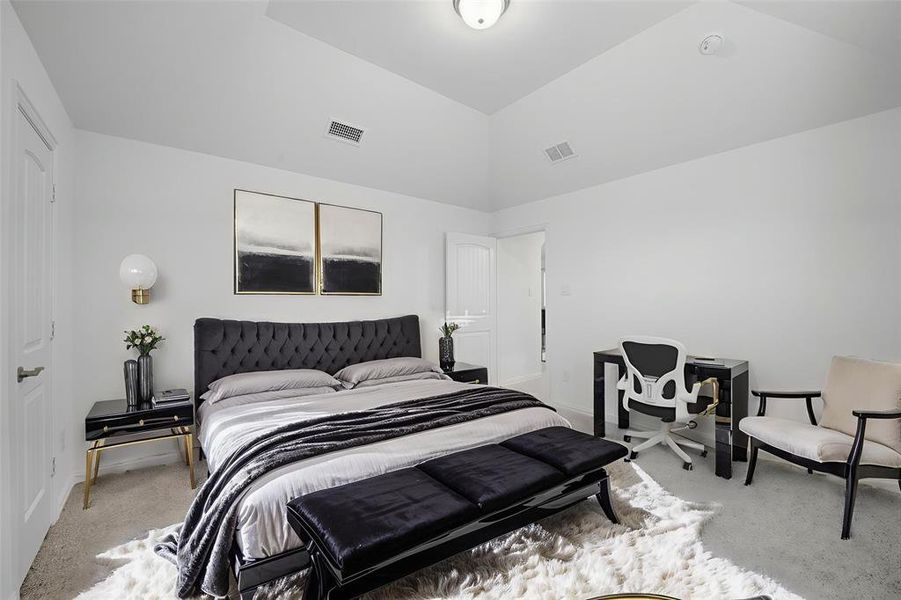 Carpeted bedroom with baseboards and vaulted ceiling Carpeted bedroom with baseboards and vaulted ceiling