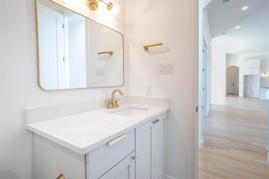 Bathroom with hardwood / wood-style flooring and vanity