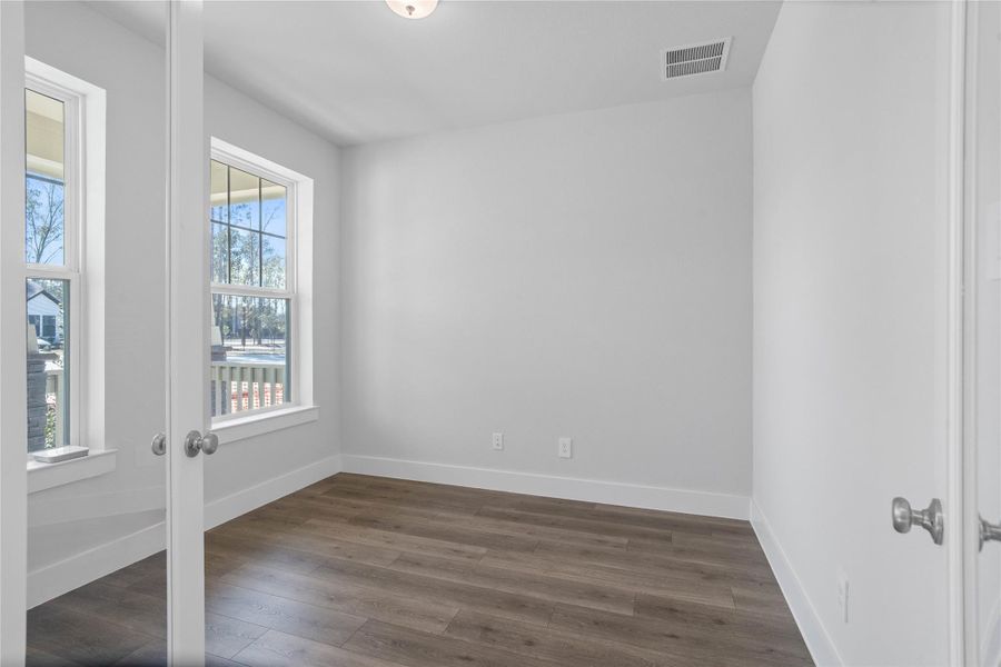 The study provides the quiet retreat necessary for a productive home office, eliminating the daily commute and maximizing work-from-home efficiency. It features French doors, neutral toned walls, and large windows.