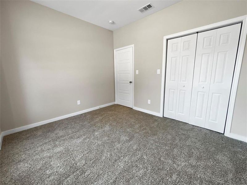 Unfurnished bedroom with carpet and a closet