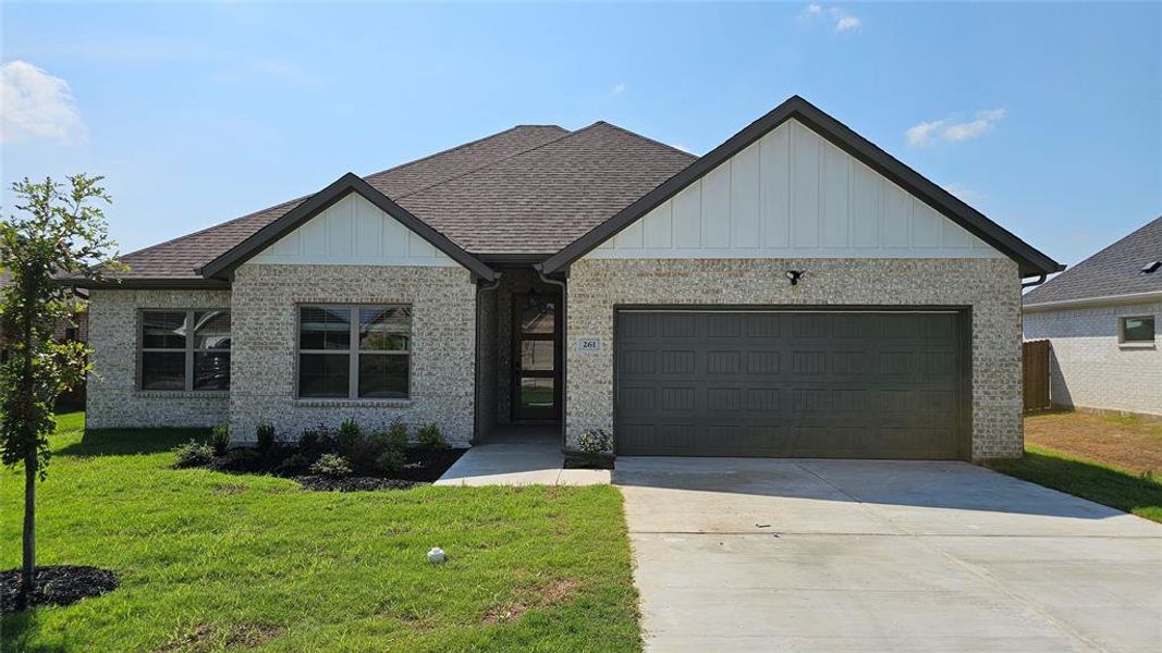 View of front facade with a garage and a front yard