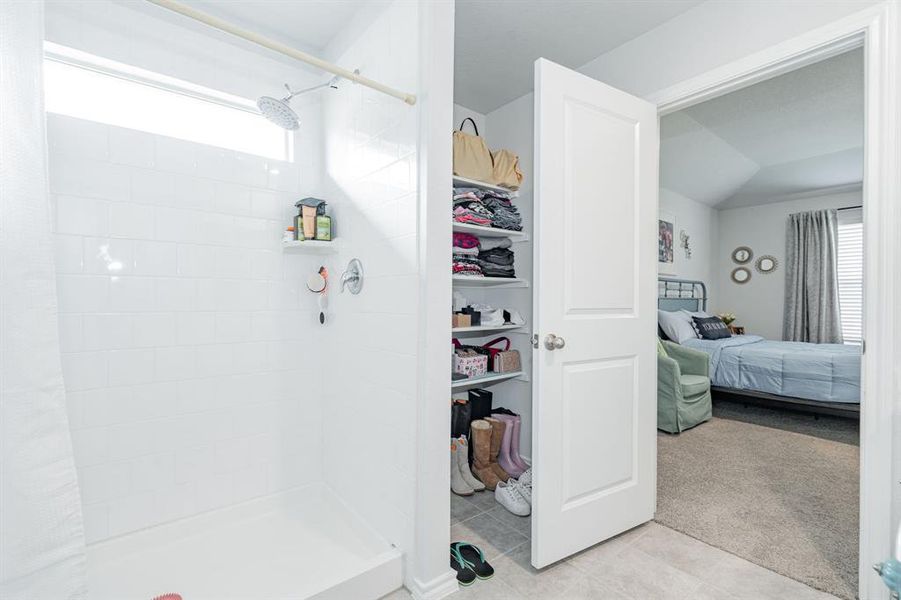 Bathroom featuring tile patterned floors, a stall shower, and ensuite bathroom