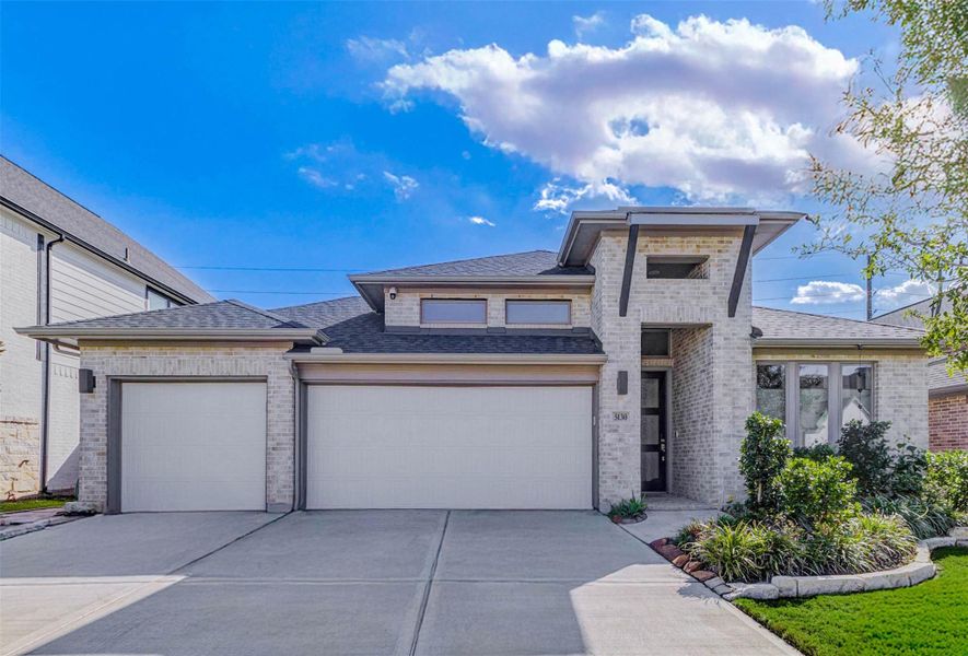 Front exterior of a new home in Cross Creek West 55', Fulshear, TX, highlighting curb appeal (Image 2).