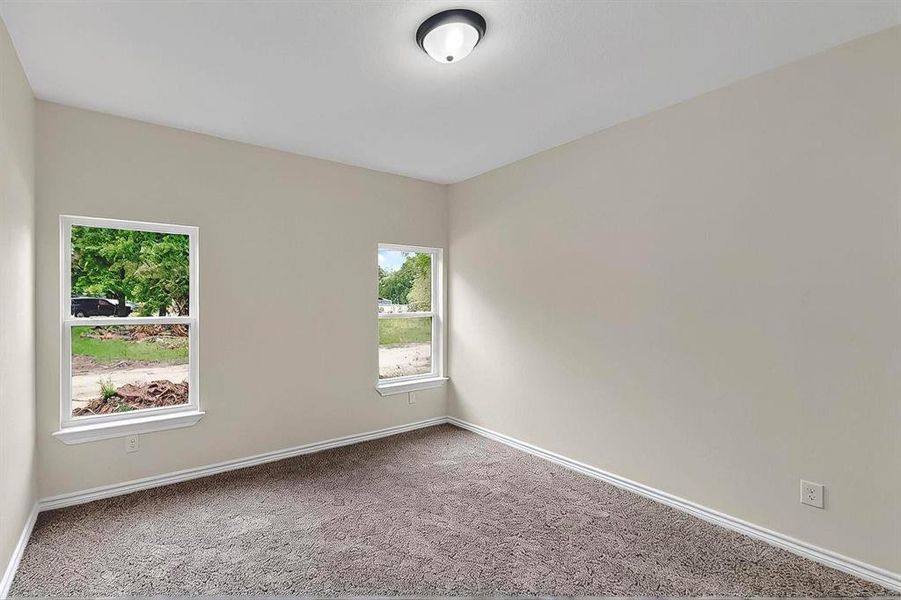 Unfurnished room with carpet floors and baseboards Unfurnished room with carpet floors and baseboards