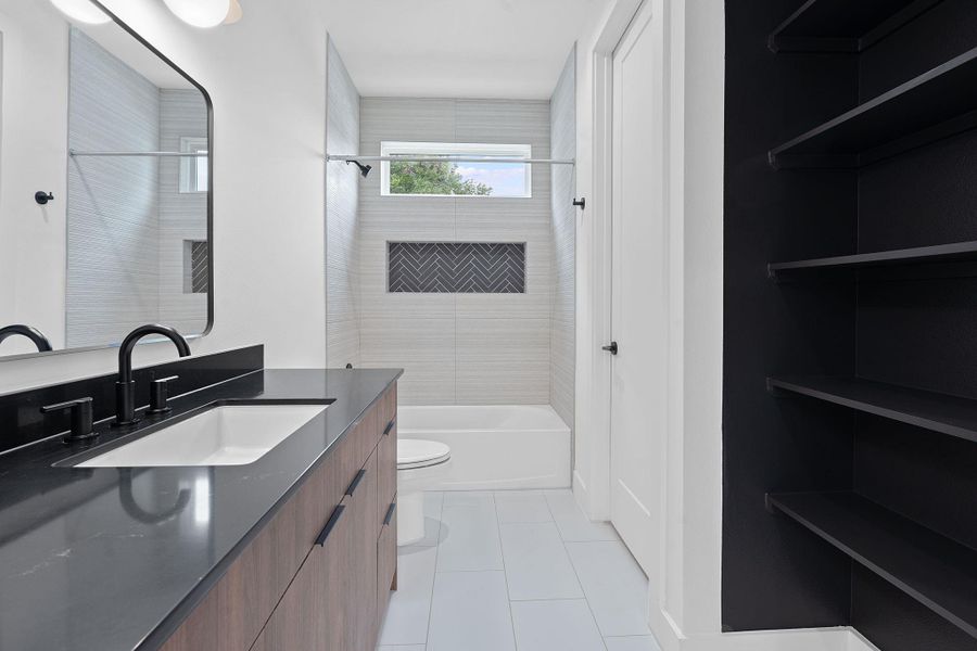 Bathroom featuring vanity,  shower combination, and tile patterned floors