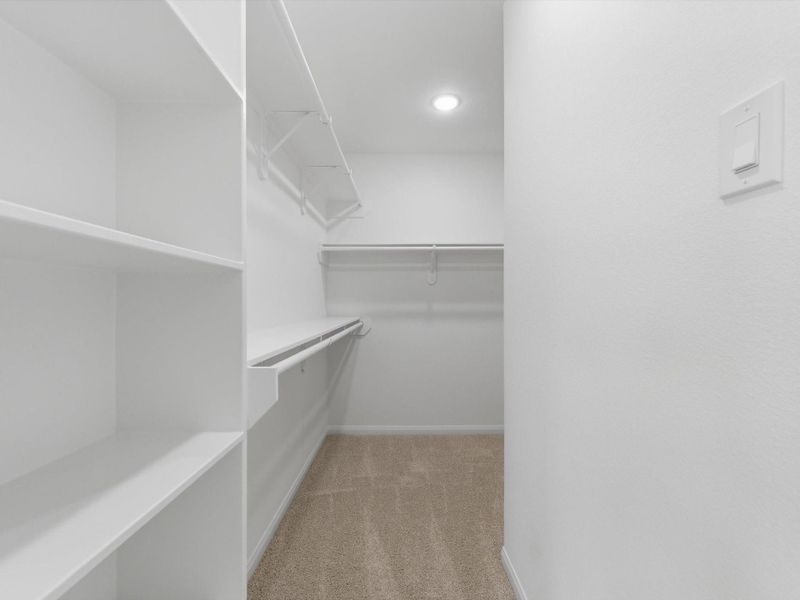 The expansive primary walk-in closet offers generous built-in storage and exceptional organization.