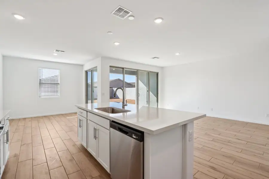 Dining, kitchen and great room. Kitchen featuring the Coastal Collection. Representative images and renderings are for illustrative purposes. Actual structural options and design finishes of home may vary.