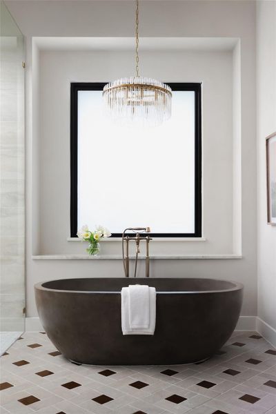 Privacy meets technology. The primary bath features smart glass technology, allowing for instant privacy at the touch of a button while still letting in natural light. With expansive dual vanities and designer lighting, the space is as functional for a morning routine as it is for a relaxing evening.