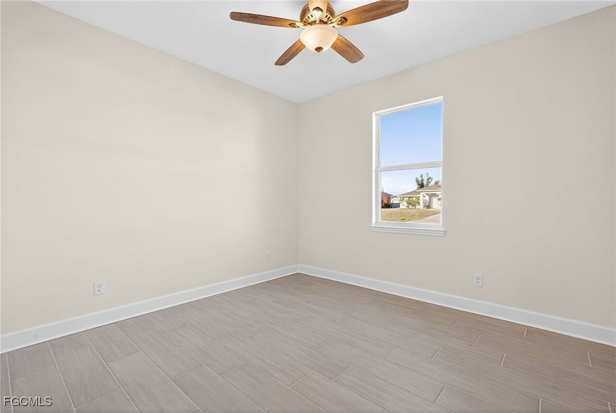Unfurnished room with wood finish floors and ceiling fan