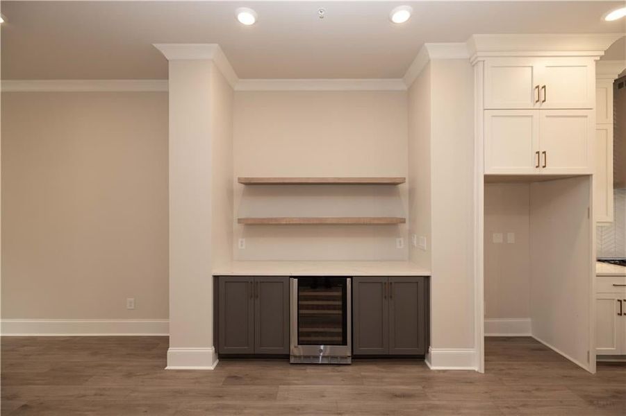 Bar features Creekstone color cabinets that match with kitchen island and Cambria Inverness Frost Gloss Quartz top with pine wood floating shelves. Really makes the perfect space to entertain!!