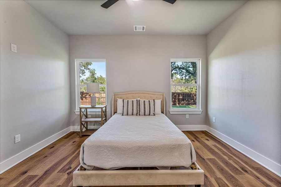 Bedroom with ceiling fan and wood finished floors Bedroom with ceiling fan and wood finished floors