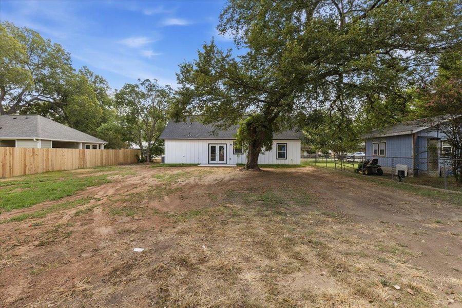 Mature shade trees and a spacious lawn frame the rear of this home. Mature shade trees and a spacious lawn frame the rear of this home.